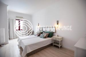 a bedroom with a bed and a sign on the wall at Ericeira Lounge Seaside Apartment in Ericeira +33 photos