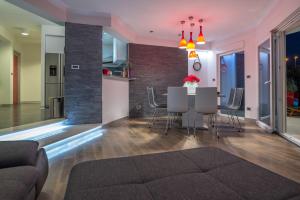 a dining room and living room with a table and chairs at Luxury apartment Shelena in Mravince