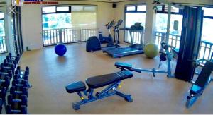 a gym with several treadmills and exercise bikes at Fully Furnished 1BR Condo Unit in Cagayan de Oro