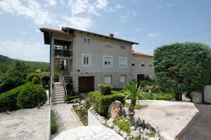 a large house with a garden in front of it at Apartments Frkovic in Ledenice