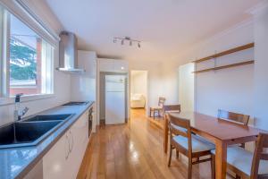 a kitchen with a table and a dining room at Rent Melbourne in Melbourne