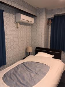 Postel nebo postele na pokoji v ubytování Hatoya Hotel
