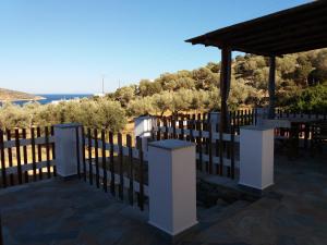 a white fence with a view of the ocean at Studios Evdokia in Platis Gialos