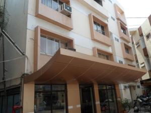 a building with an awning in front of it at Hotel Vaishali in Nashik