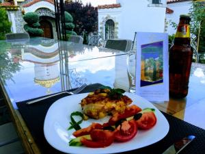 a plate of food with tomatoes on a table at Villa St. Michael in Madara