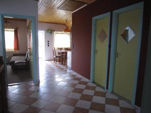 a hallway of a house with a checkerboard floor at Fanni Guest House in Balatonvilágos +10 photos