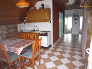 a kitchen with a table and a stove top oven at Fanni Guest House in Balatonvilágos