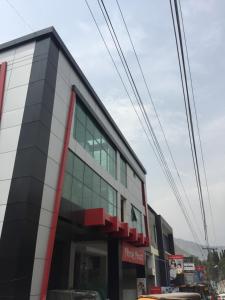 a building with glass windows on the side of it at AAKAS Hotel & Restaurant in Muzaffarabad +19 photos