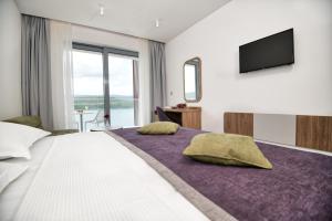 Postel nebo postele na pokoji v ubytování Hotel Nova