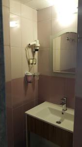 a bathroom with a sink and a mirror at Buyuk Hotel in Kayseri