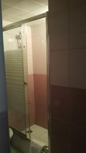 a bathroom with a glass shower with a mirror at Buyuk Hotel in Kayseri