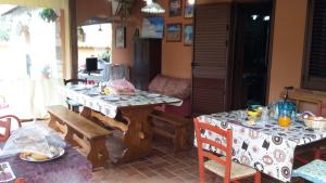a kitchen with two tables and a table and chairs at Villa Salvatore in San Leone