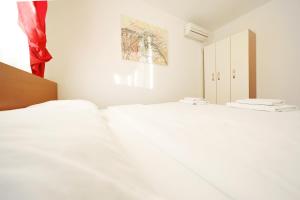 Postel nebo postele na pokoji v ubytování Apartmani "Jadran"