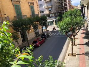 a red car parked on the side of a street at Apartment De Rossi in Bari