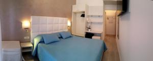 Posteľ alebo postele v izbe v ubytovaní Hotel Acapulco