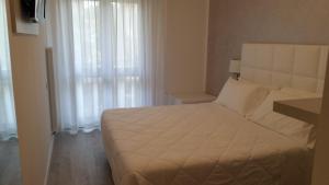 Posteľ alebo postele v izbe v ubytovaní Hotel Acapulco