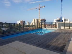 a swimming pool on the roof of a building with crane at 126 Beacon Rock in Durban