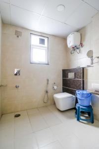 a bathroom with a toilet and a sink and a window at Lila's Abode - Homestay in Jaipur