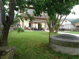 a house with a fire pit in a yard at Don Felix Hotel in Ríoseco