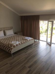 Postel nebo postele na pokoji v ubytování David Palace Hotel Ureki