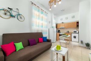 a living room with a couch and a bike on the wall at Maximos Sea & The City in Rhodes Town