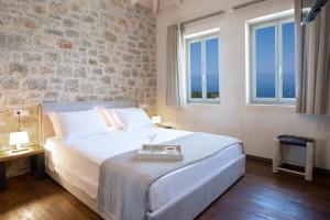 a bedroom with a bed with a tray on it at Ionian Horizon Villas in Tsoukalades
