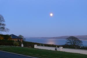 a view of the moon over the water at Templeview Lodge in Greencastle