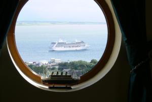 a cruise ship in the ocean viewed through a window at Templeview Lodge in Greencastle