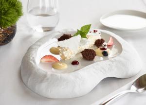 a white plate topped with a piece of cake at Boutique 5 Hotel & Spa - Adults Only in Kiotari