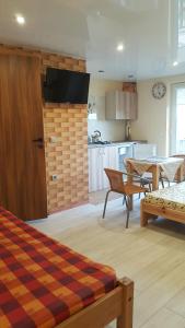 a living room with a table and a kitchen at Žuvėdrų g. 27 in Šventoji