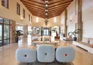 a lobby with two chairs and a table at Boutique 5 Hotel & Spa - Adults Only in Kiotari