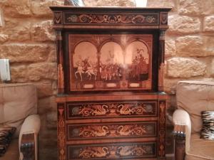 
a wooden table topped with a wooden armoire at B&B La Casa Di El in Agrigento
