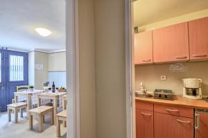 a kitchen and dining room with a table and chairs at Room Zimmer Portarol in Vodnjan +28 photos