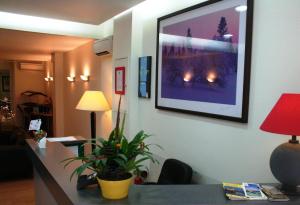 a room with a desk with a picture on the wall at Hotel Boreal in Toulouse