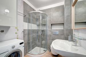 a bathroom with a shower and a sink at Apartament Jantar Park in Jantar