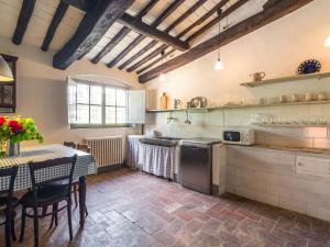 a kitchen with a table and a dining room at Plush Farmhouse in Bacchereto with Swimming Pool in Carmignano