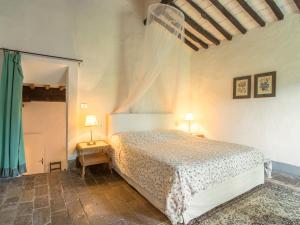 a bedroom with a bed and two lamps on tables at Plush Farmhouse in Bacchereto with Swimming Pool in Carmignano