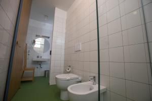 a bathroom with a toilet and a sink at Senia_rooms_design in Santa Maria al Bagno