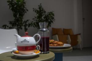 a table with a tea kettle and a plate of food at Senia_rooms_design in Santa Maria al Bagno +50 photos