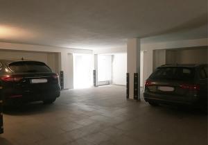 two cars parked in an empty parking garage at Appartamenti fronte mare in Castiglioncello