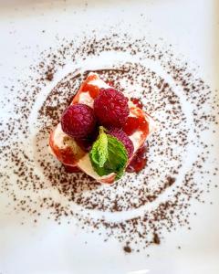 a white plate topped with a dessert covered in strawberries at Nambiti Plains in Nambiti Game Reserve