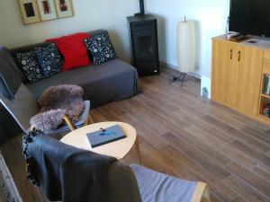 a living room with a couch and a table at Bungalow am Werratal Radwanderweg in Breitungen