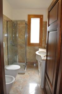 a bathroom with a shower and a toilet and a sink at Appartamenti fronte mare in Castiglioncello
