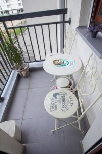 a white table and chair on a balcony at Apartment Barby - Deluxe in Banja Luka