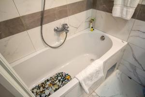 a white bath tub with a faucet in a bathroom at Apartment Barby - Deluxe in Banja Luka