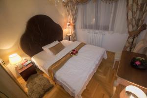 a bedroom with a large bed with flowers on it at Apartment Barby - Deluxe in Banja Luka