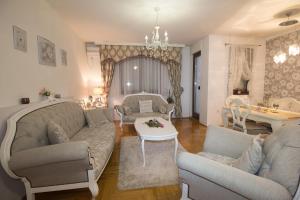 a living room with a couch and chairs and a table at Apartment Barby - Deluxe in Banja Luka