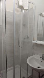 a bathroom with a shower, sink, and toilet at Hotel Dorico in Ancona
