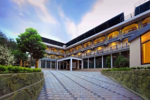 an exterior view of a building with a driveway at Sr Palaceinn in Kolattupuzha