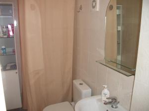 a bathroom with a toilet and a sink and a mirror at Studio Elli in Zakynthos Town